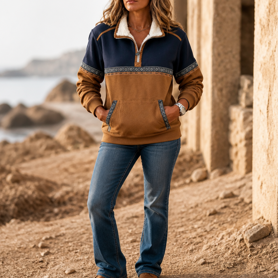 Colorblock sherpa half-zip pullover with navy upper panel, brown pocket, and patterned yoke