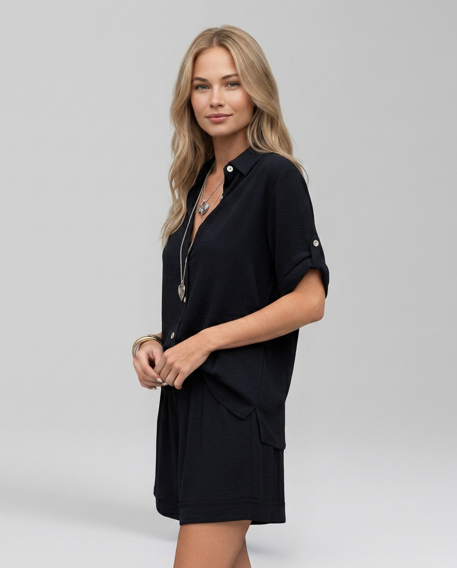 Black collared short-sleeve top with side pockets and matching shorts