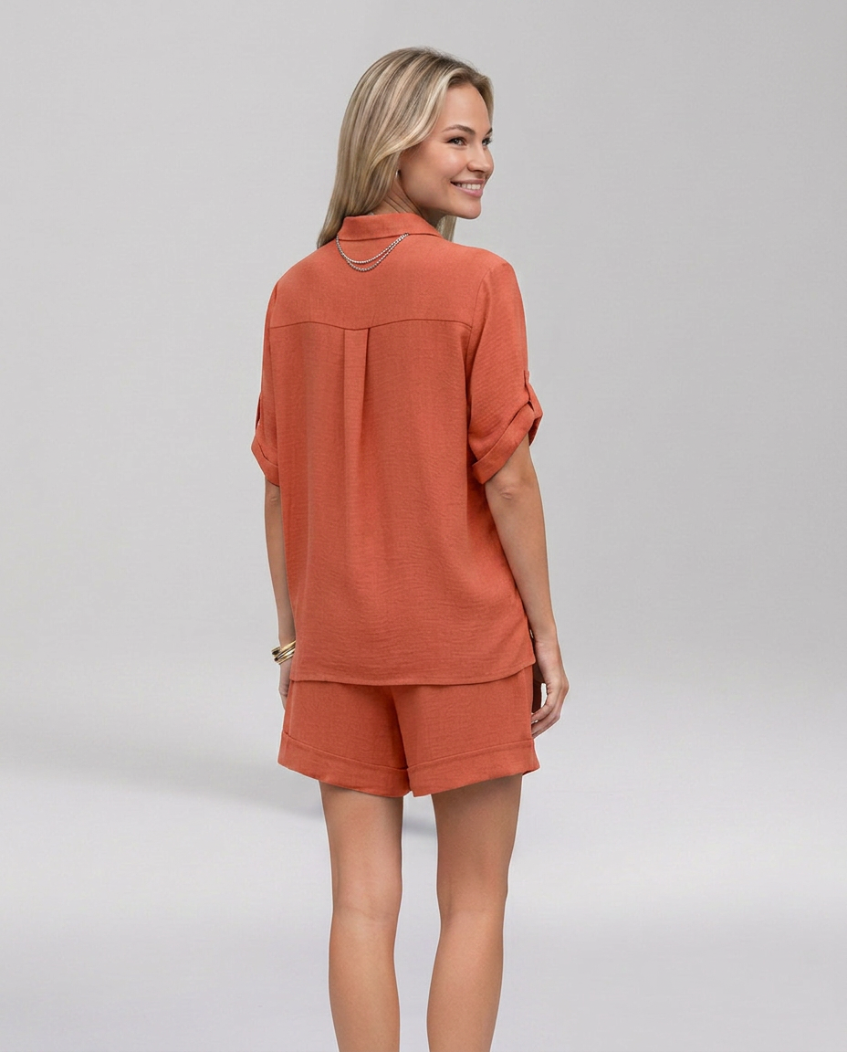 Rust-orange collared short-sleeve top with side pockets and matching shorts