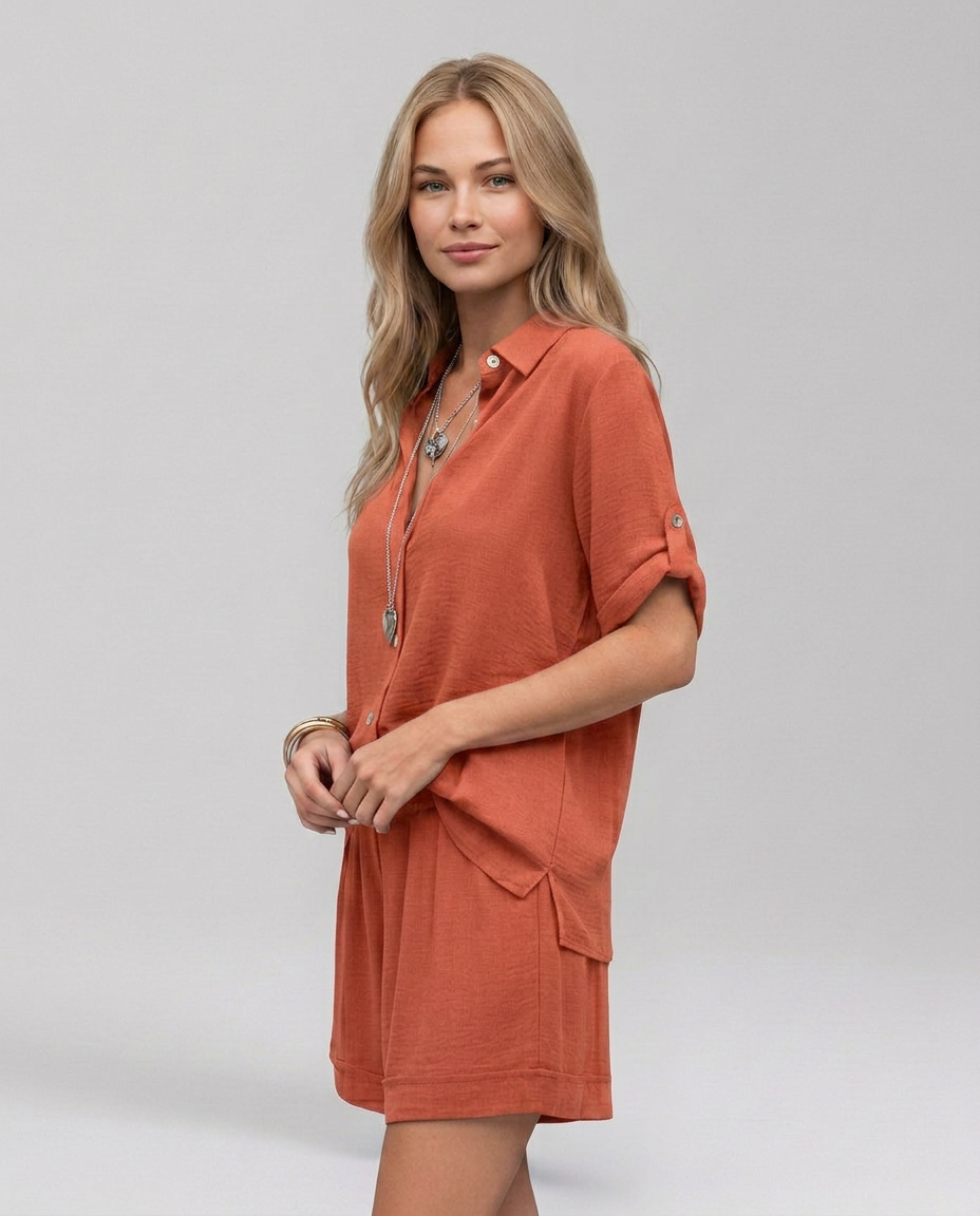 Rust-orange collared short-sleeve top with button placket and matching shorts