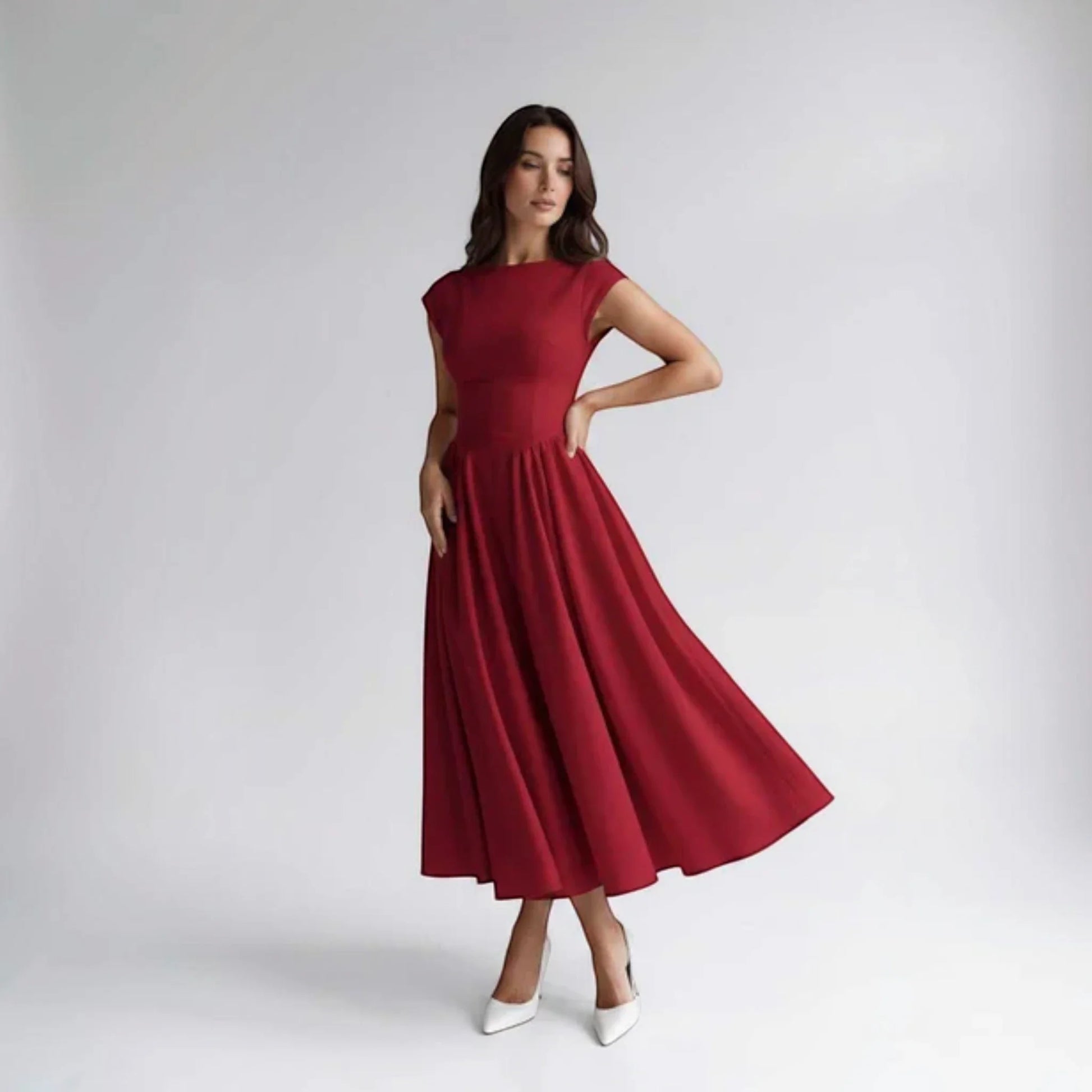 Red sleeveless fit-and-flare midi dress with fitted bodice and pleated skirt