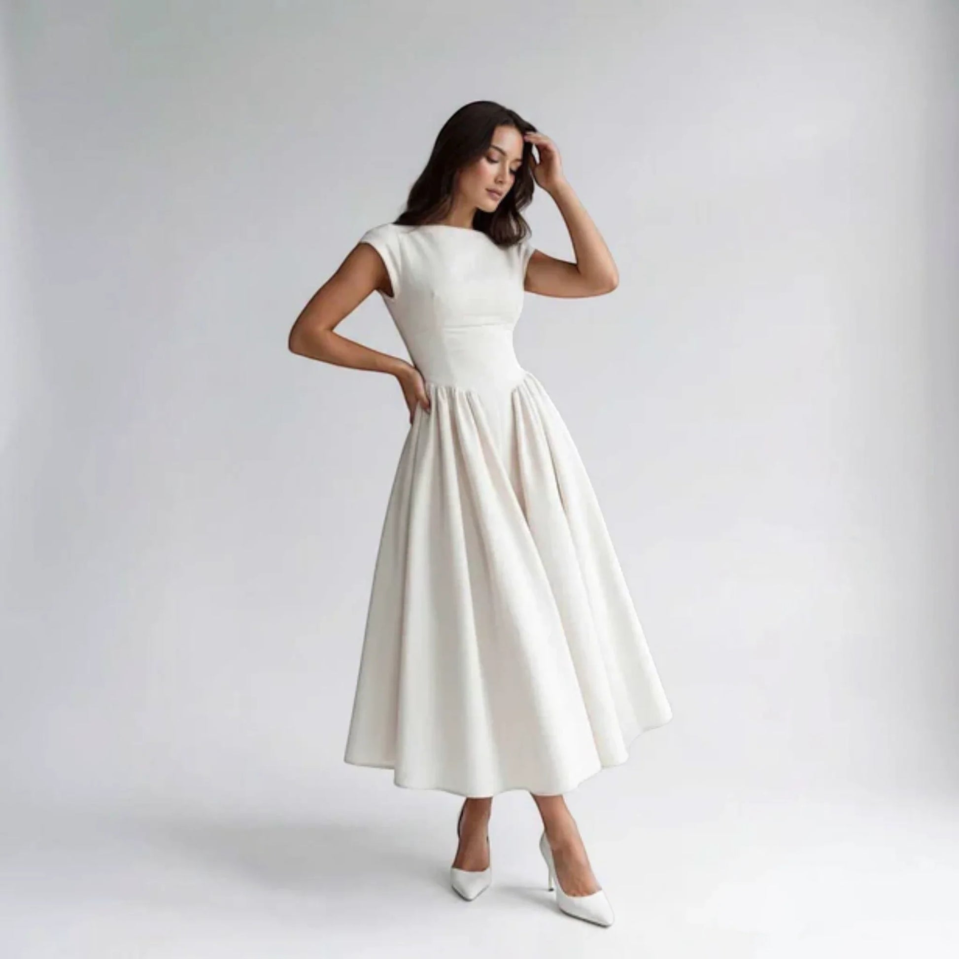 White sleeveless fit-and-flare midi dress with round neckline and gathered skirt