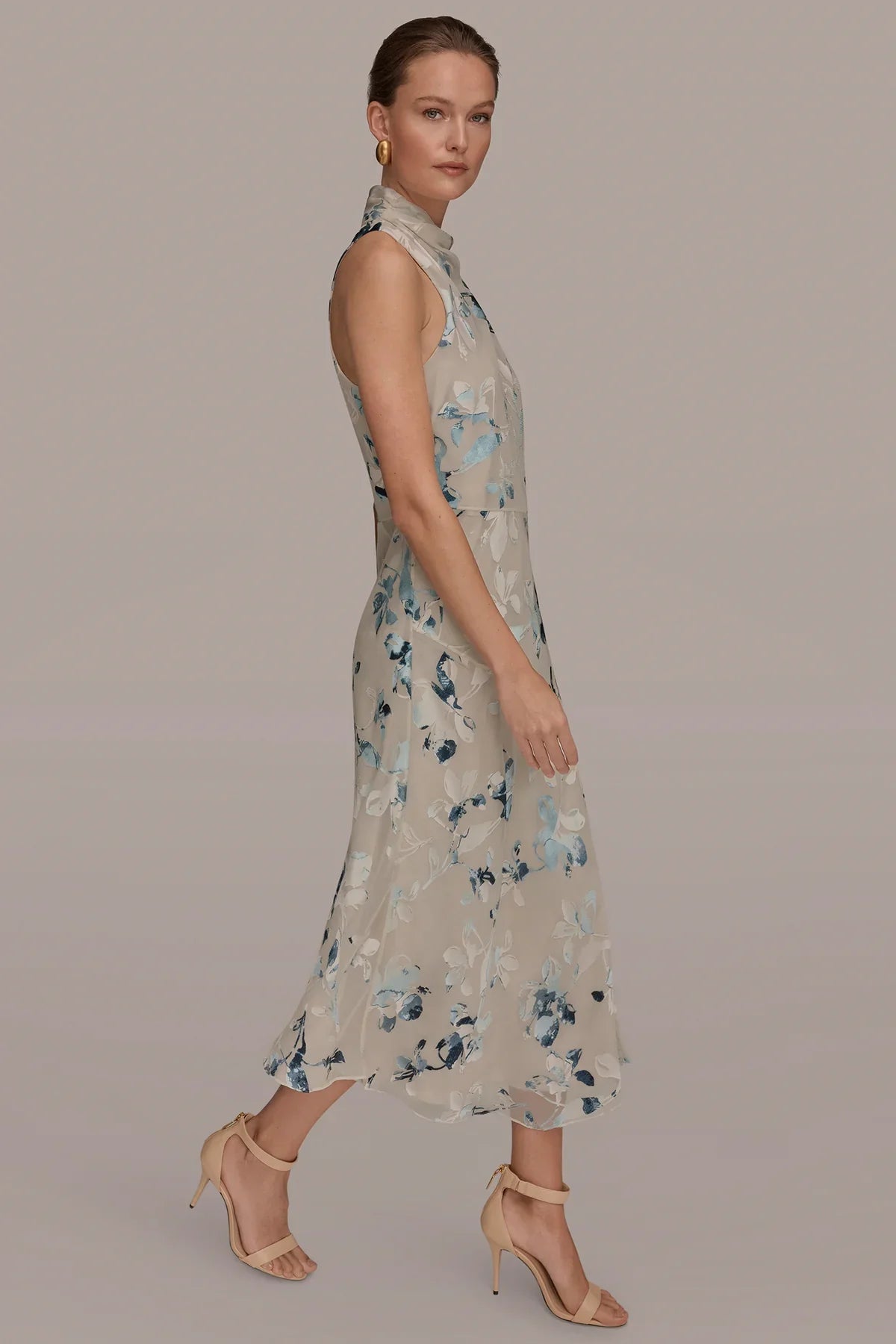 Side view of Sea Mist multi sleeveless midi dress with blue floral burnout detail, high neck.