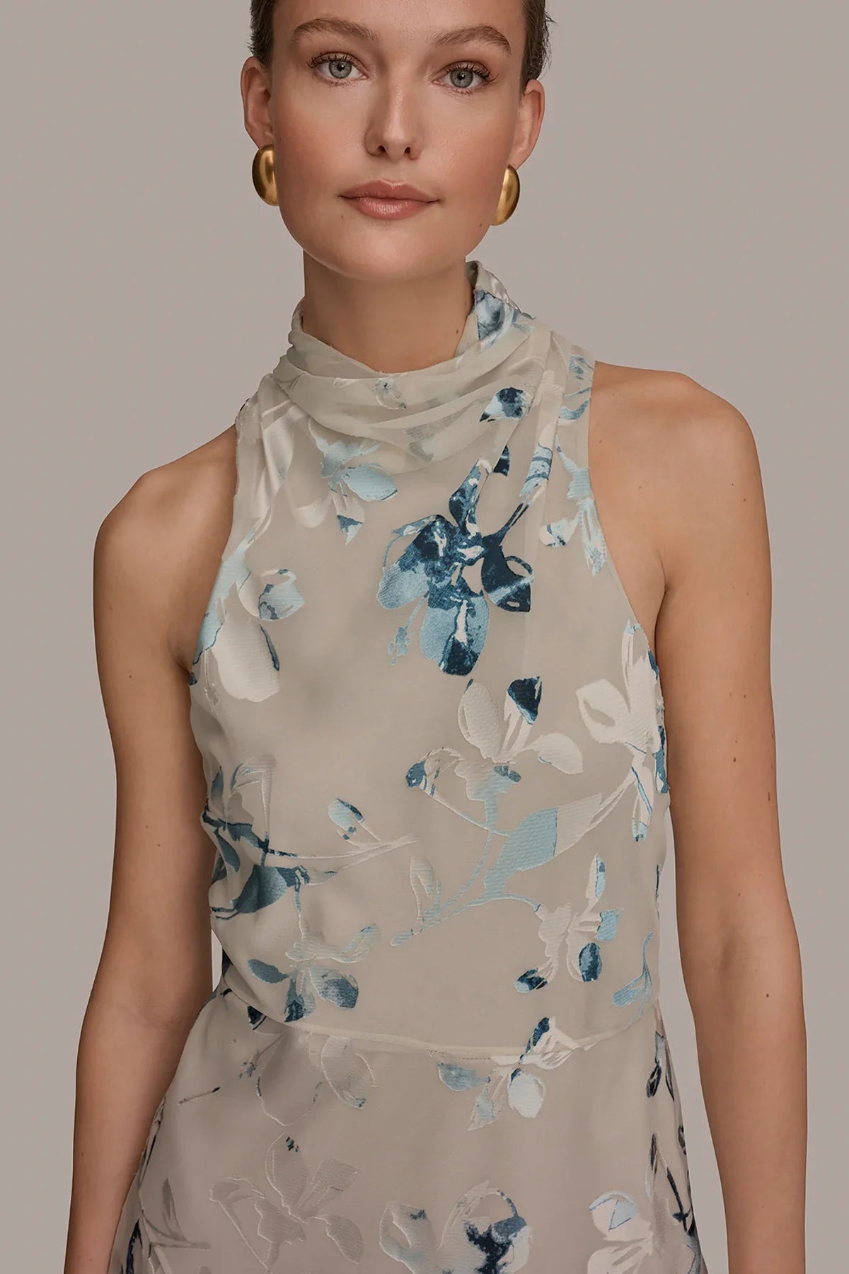Close-up of Sea Mist multi sleeveless midi dress with blue floral burnout and high neck.