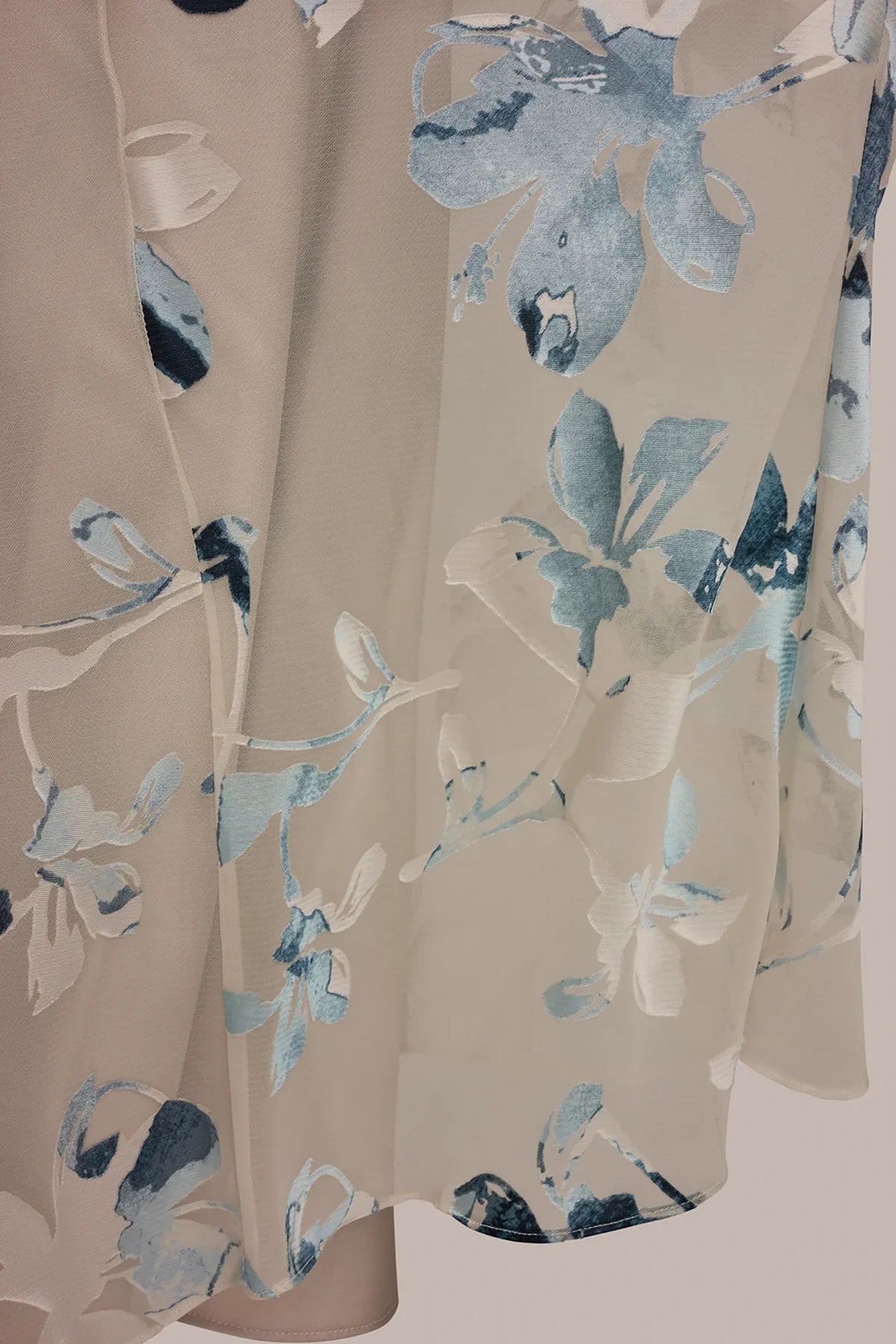 Sleeveless Sea Mist multi midi dress fabric close-up showing blue floral burnout motifs.