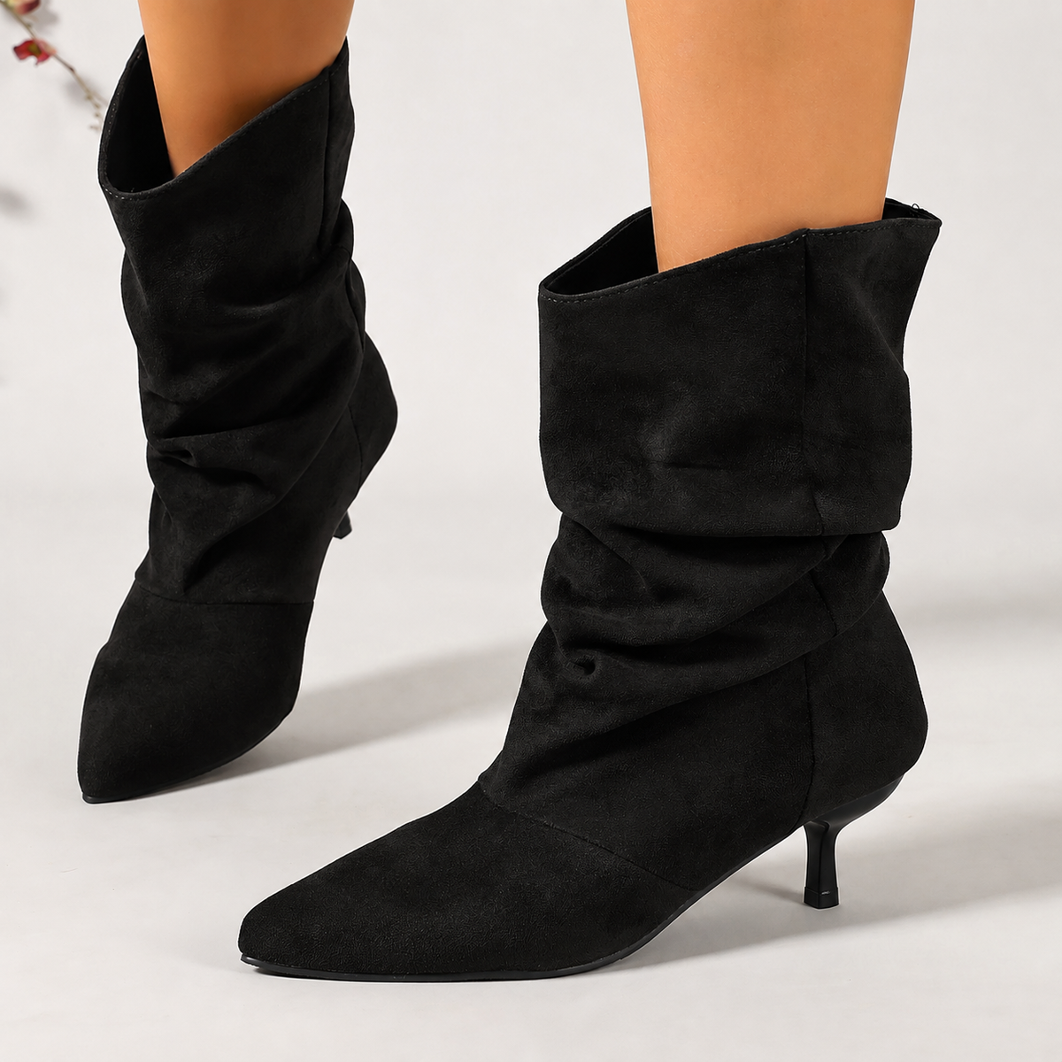 Black slouchy suede ankle boots with pointed toe and slim stiletto heel