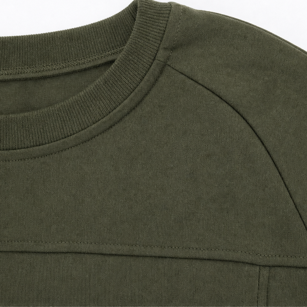 Army green tunic close-up showing ribbed crew neck and shoulder seam
