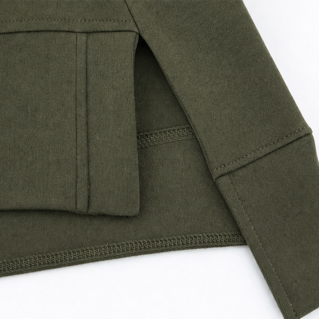 Army green tunic close-up showing side slit and stitched sleeve seam