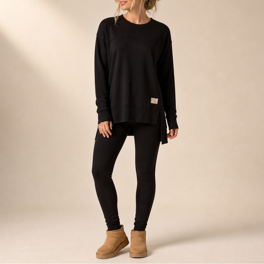 Black top and pants set with a long split-hem top and fitted pants