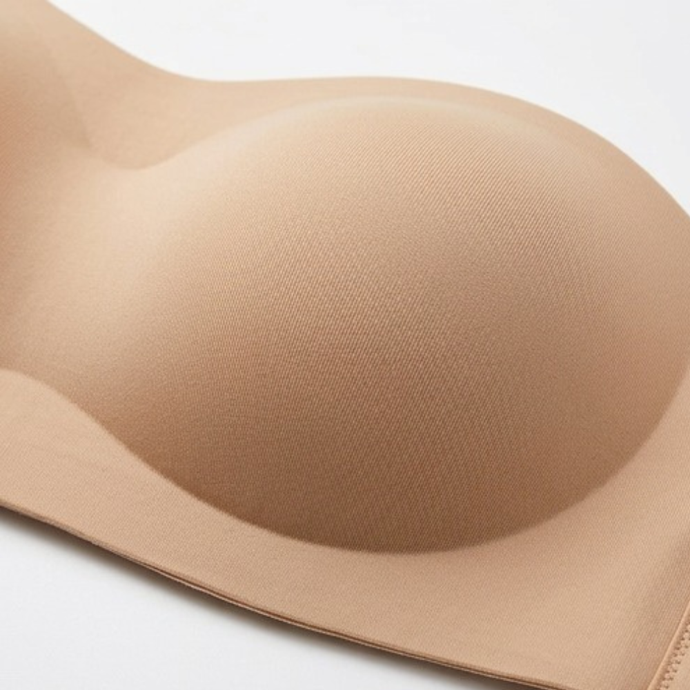 Close-up of the smooth molded cup on a camel strapless bra