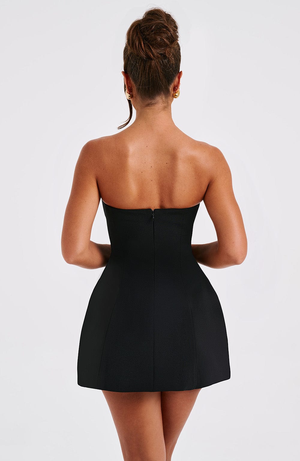 Black strapless bubble mini dress, back view with seamed bodice and flared skirt