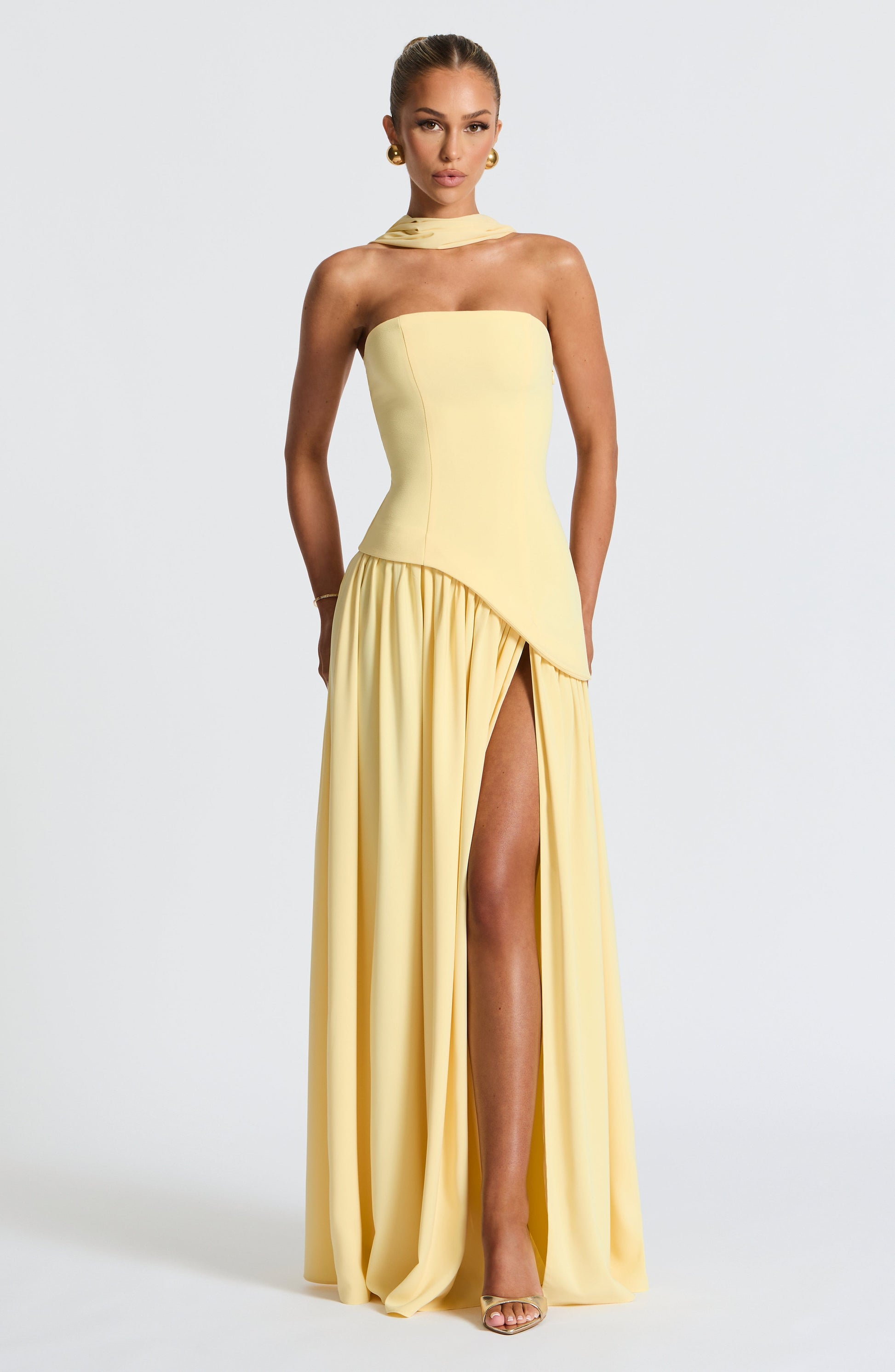 Butter yellow strapless maxi dress with side slit and draped asymmetrical panel