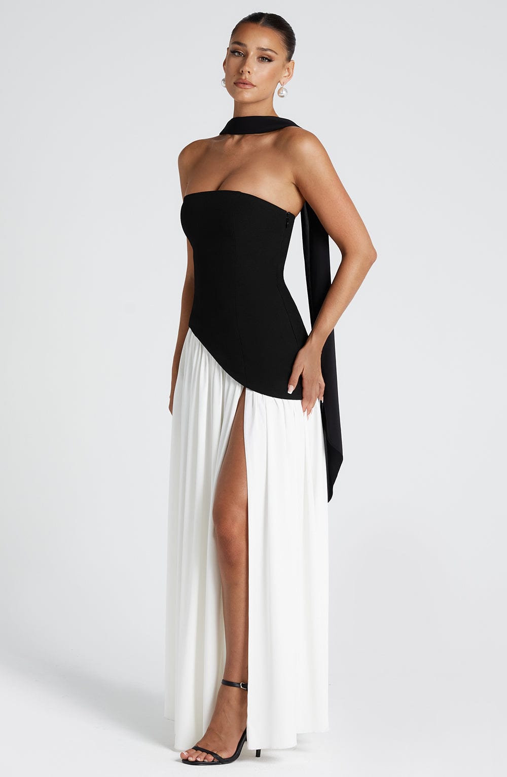 Black strapless maxi dress with side slit and flowing draped panel