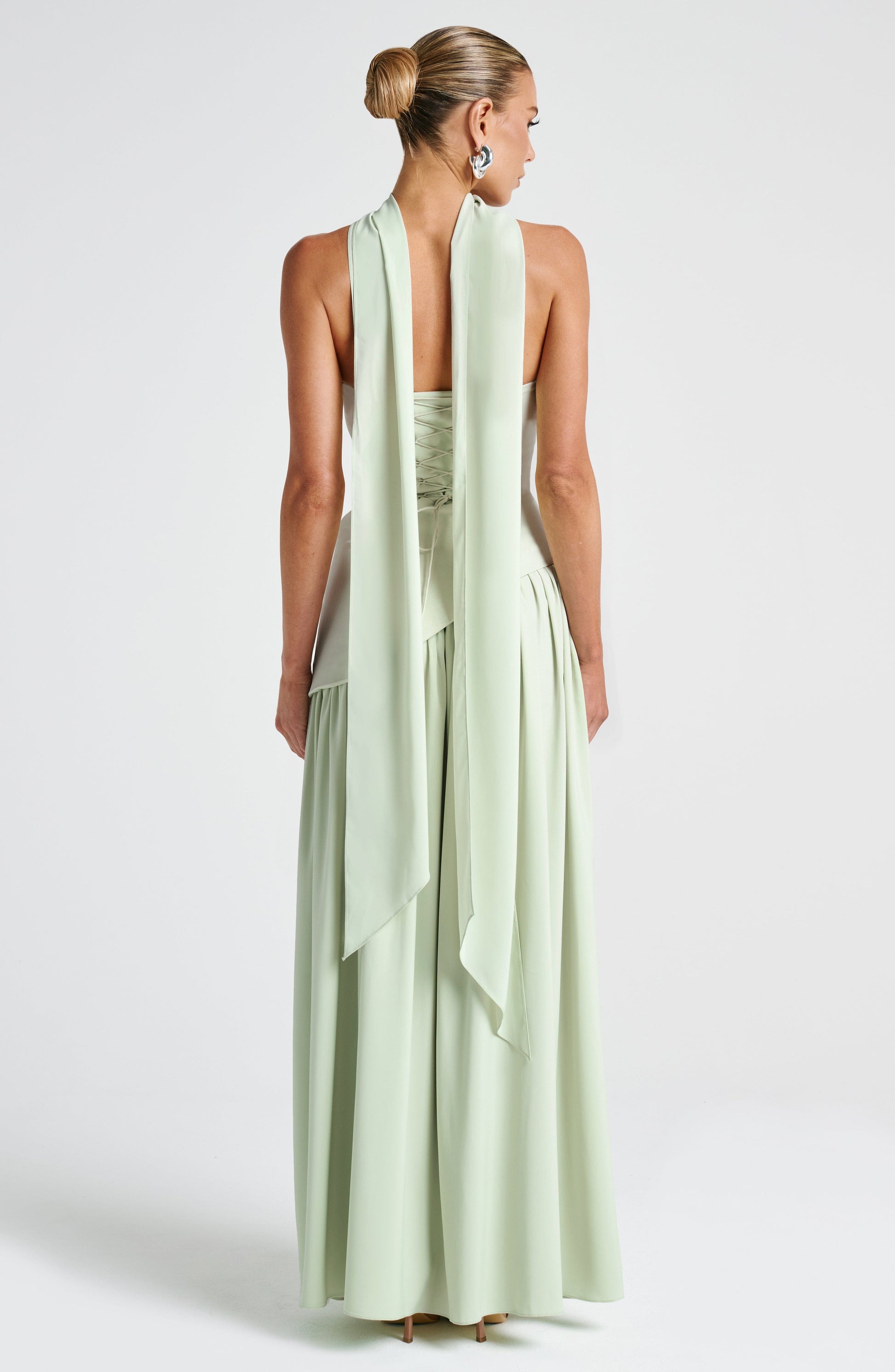 Light green strapless maxi dress with open-back drape and side slit