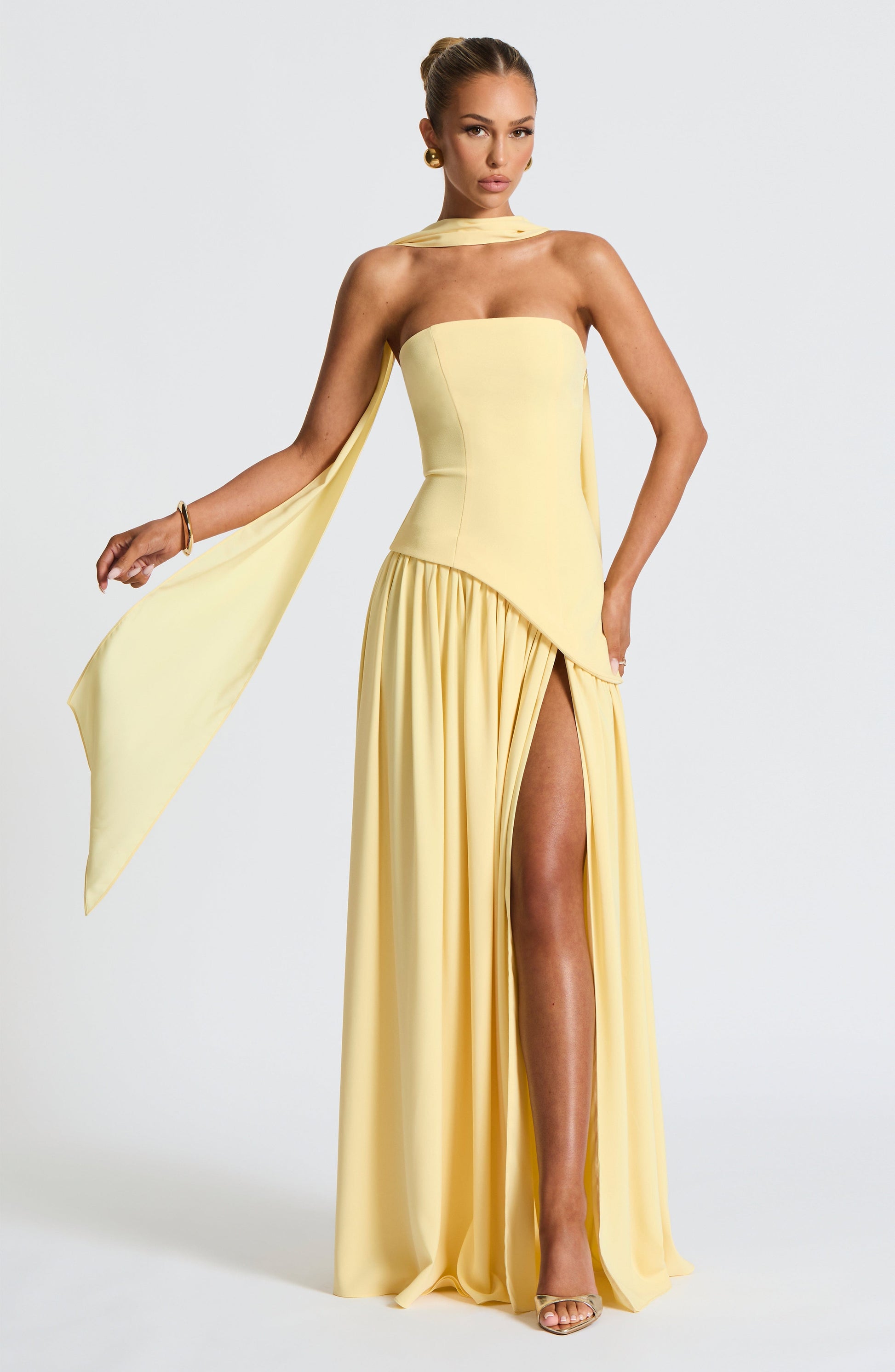 Butter yellow strapless maxi dress with side slit and flowing draped panel