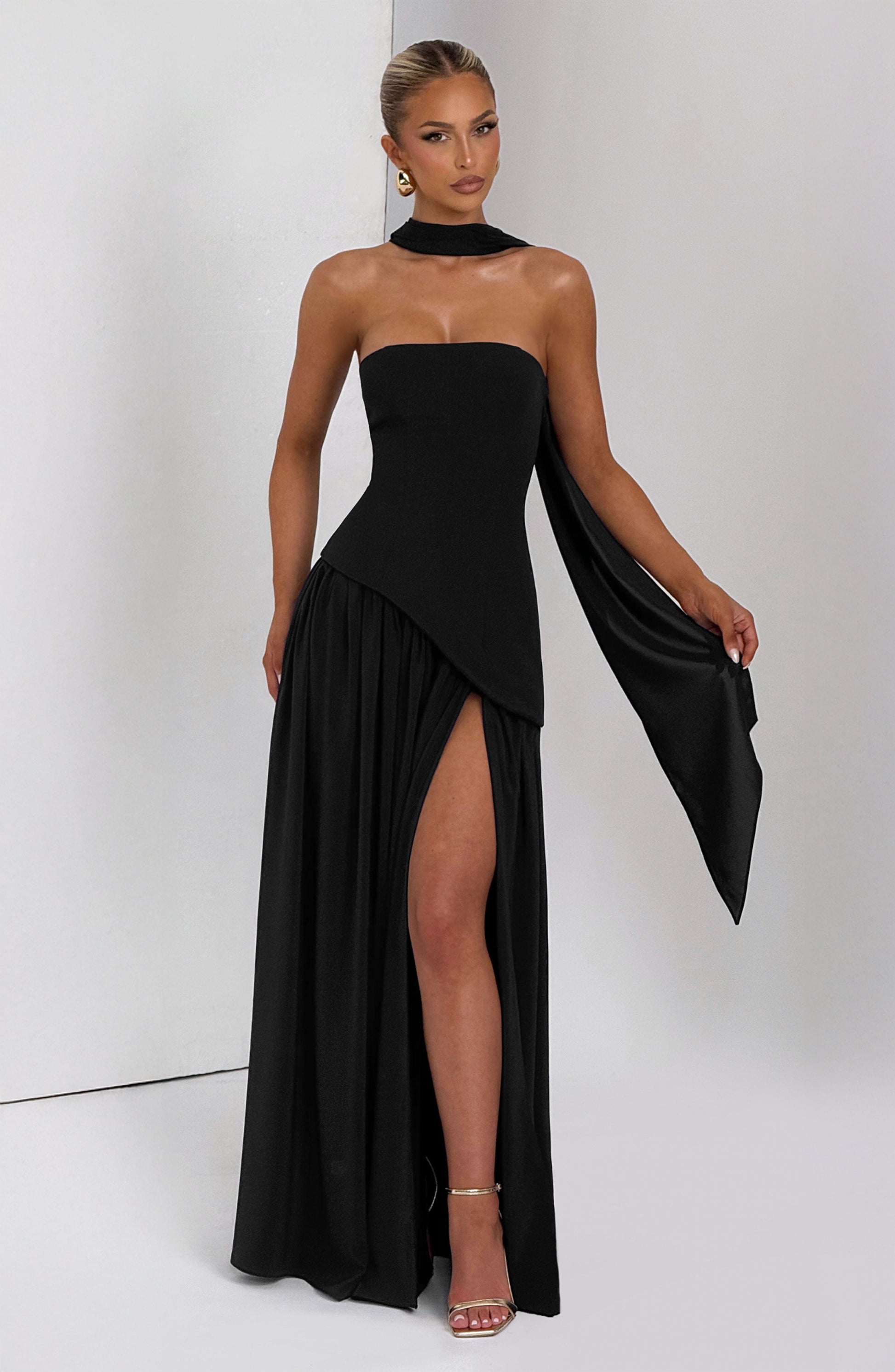 Black strapless maxi dress with asymmetric wrap overlay and side slit