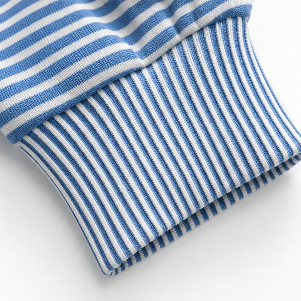 Ribbed hem cuff with blue-and-white stripes on a hooded hoodie