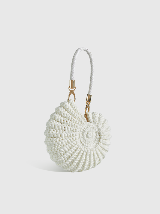 White conch-shaped handbag with textured circular shell design and two top handles