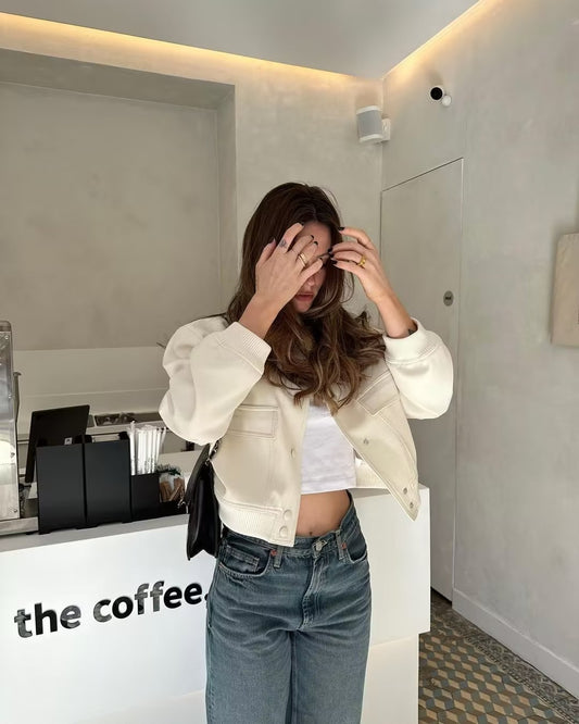 Oatmilk cropped bomber jacket with snap front, ribbed hem, and visible chest pockets