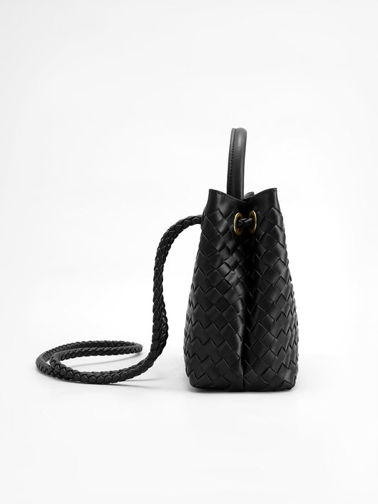 Black woven tote bag with top handle and braided shoulder strap