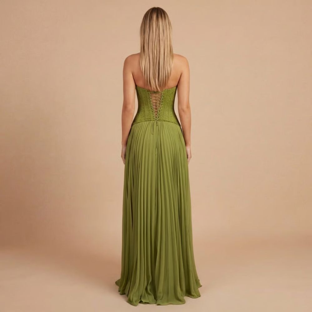 Green corset-back maxi dress with pleated skirt and thin straps.