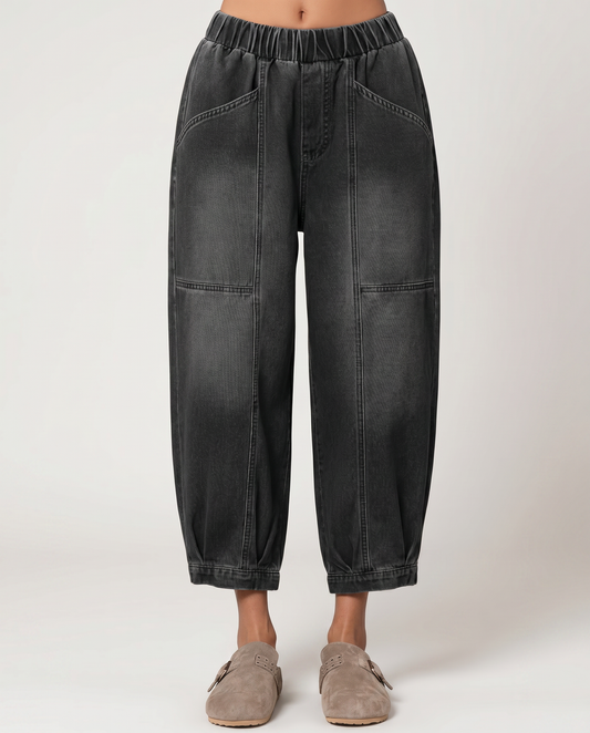 Black tapered denim jeans with elastic waistband and front cargo pockets