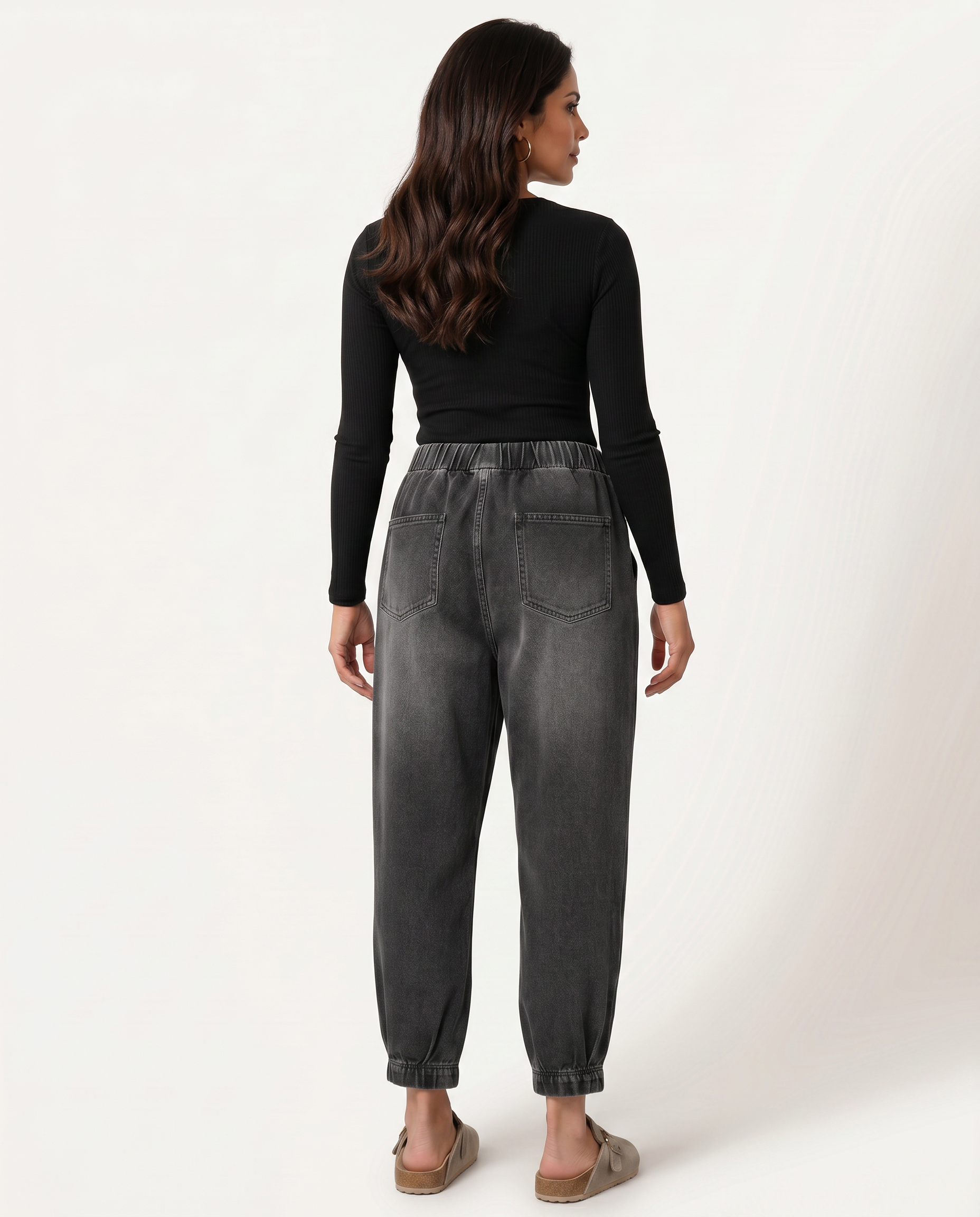 Back view black tapered denim jeans with elastic waistband and rear pockets