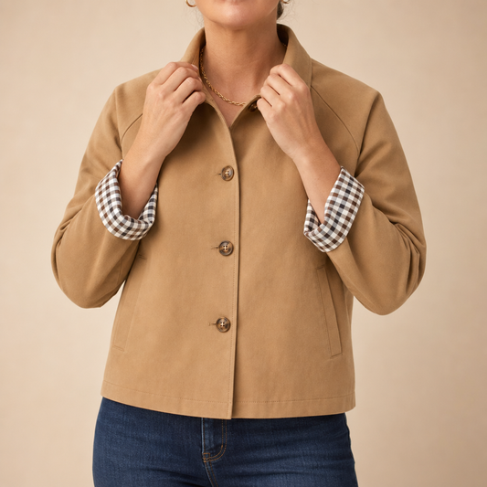 Camel casual coat with button front and black-and-white checkered raglan cuffs