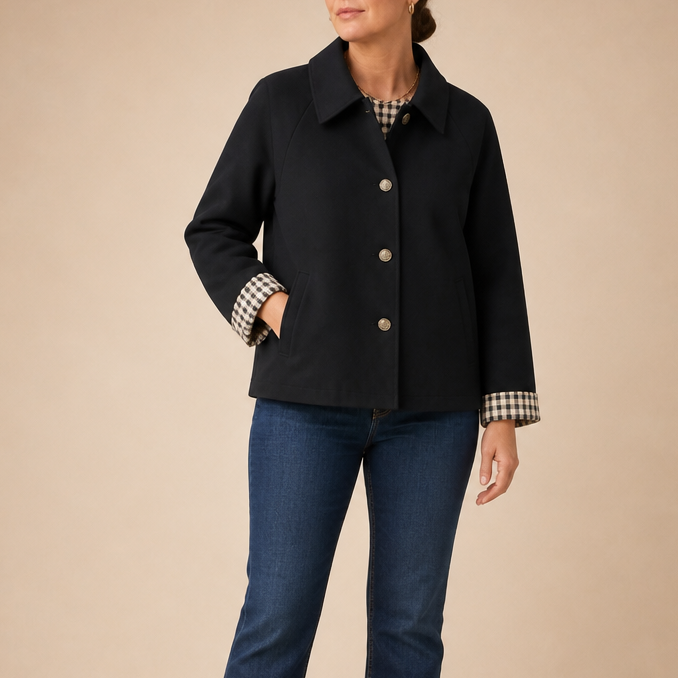 Black raglan-sleeve casual coat with button front, collar, patch pocket, and plaid cuffs