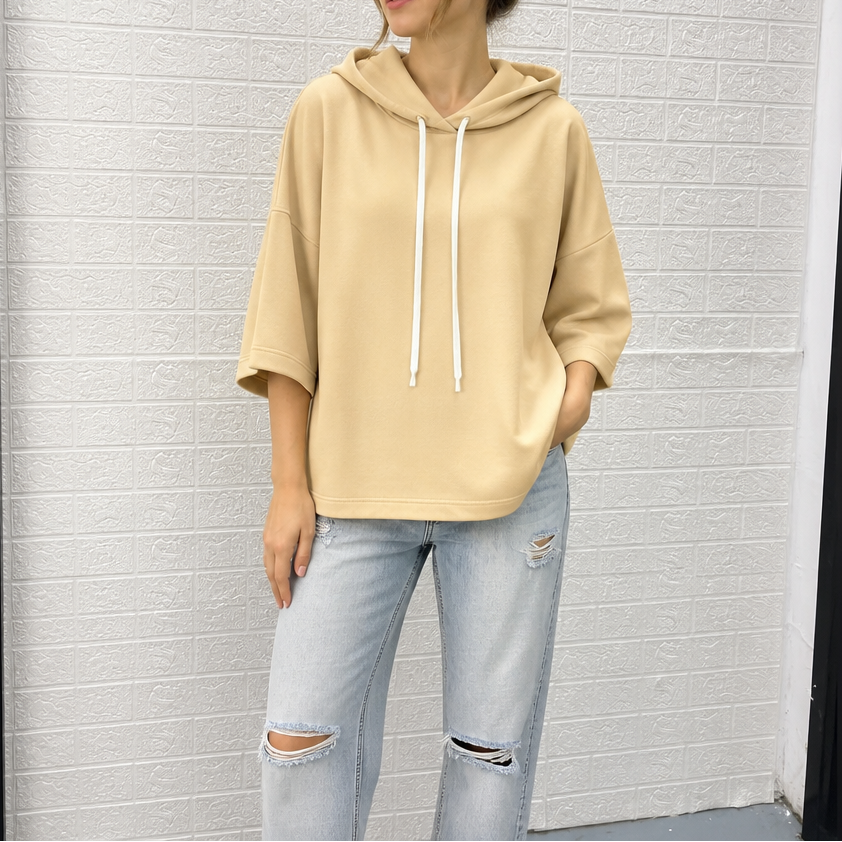 Beige three-quarter sleeve hoodie with drawstring hood and white hanging strings