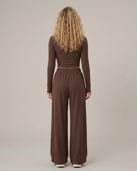 Two-piece set with brown long-sleeve top and wide-leg trousers, back view.