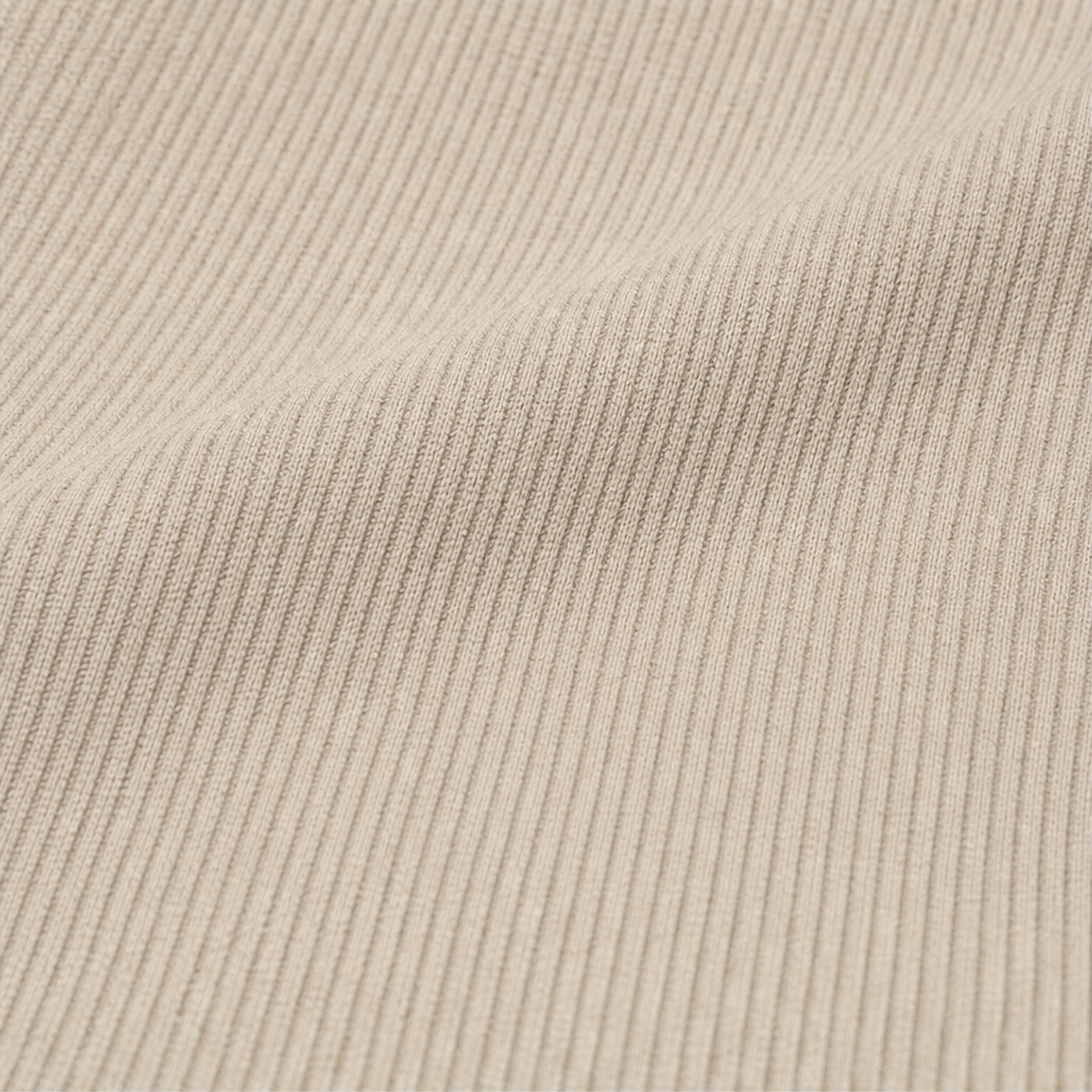 Taupe ribbed knit fabric close-up with fine vertical texture.