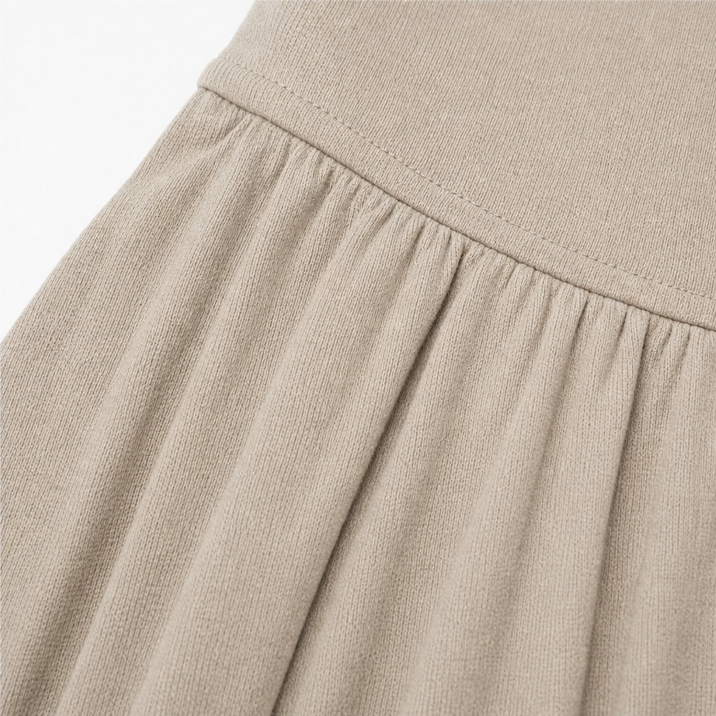 Taupe ribbed knit skirt panel with gathered pleats below waist.