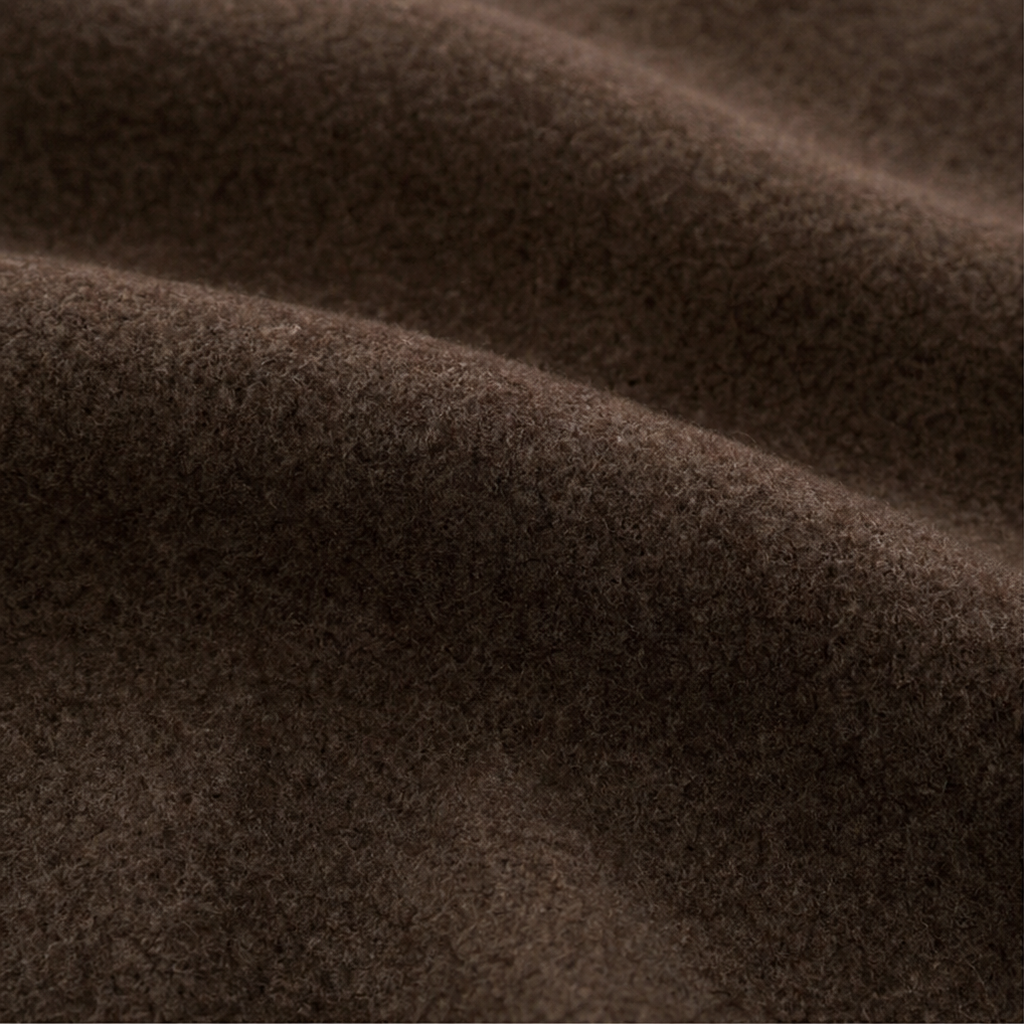 Brown textured knit fabric close-up with soft brushed surface