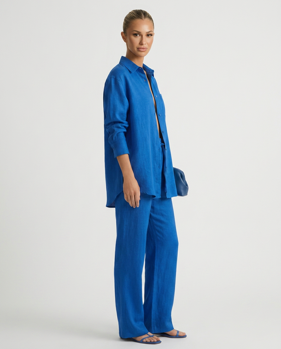Blue relaxed button-up top and matching relaxed pants set, side view
