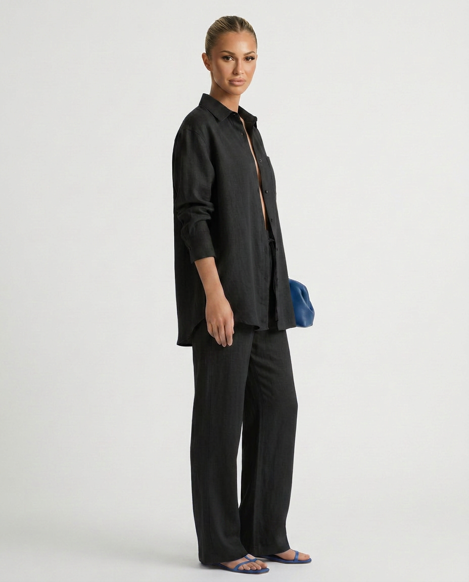 Black relaxed button-up top and matching relaxed pants set, side view