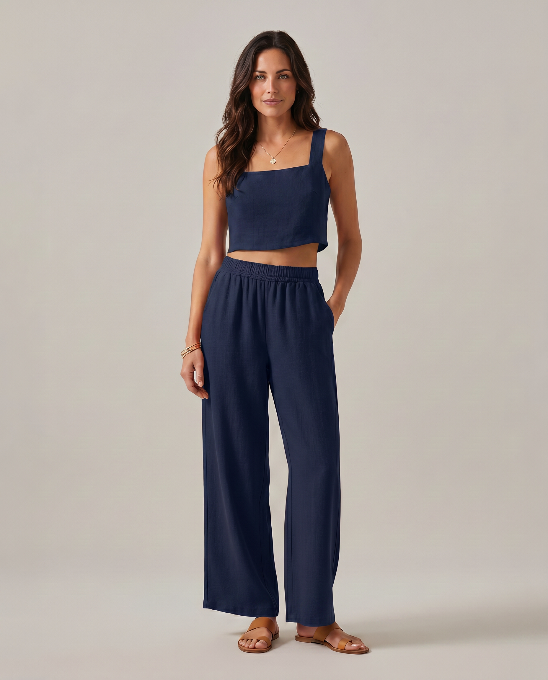 Wide-leg two-piece set in navy: square-neck cropped tank and elastic-waist wide-leg pants.