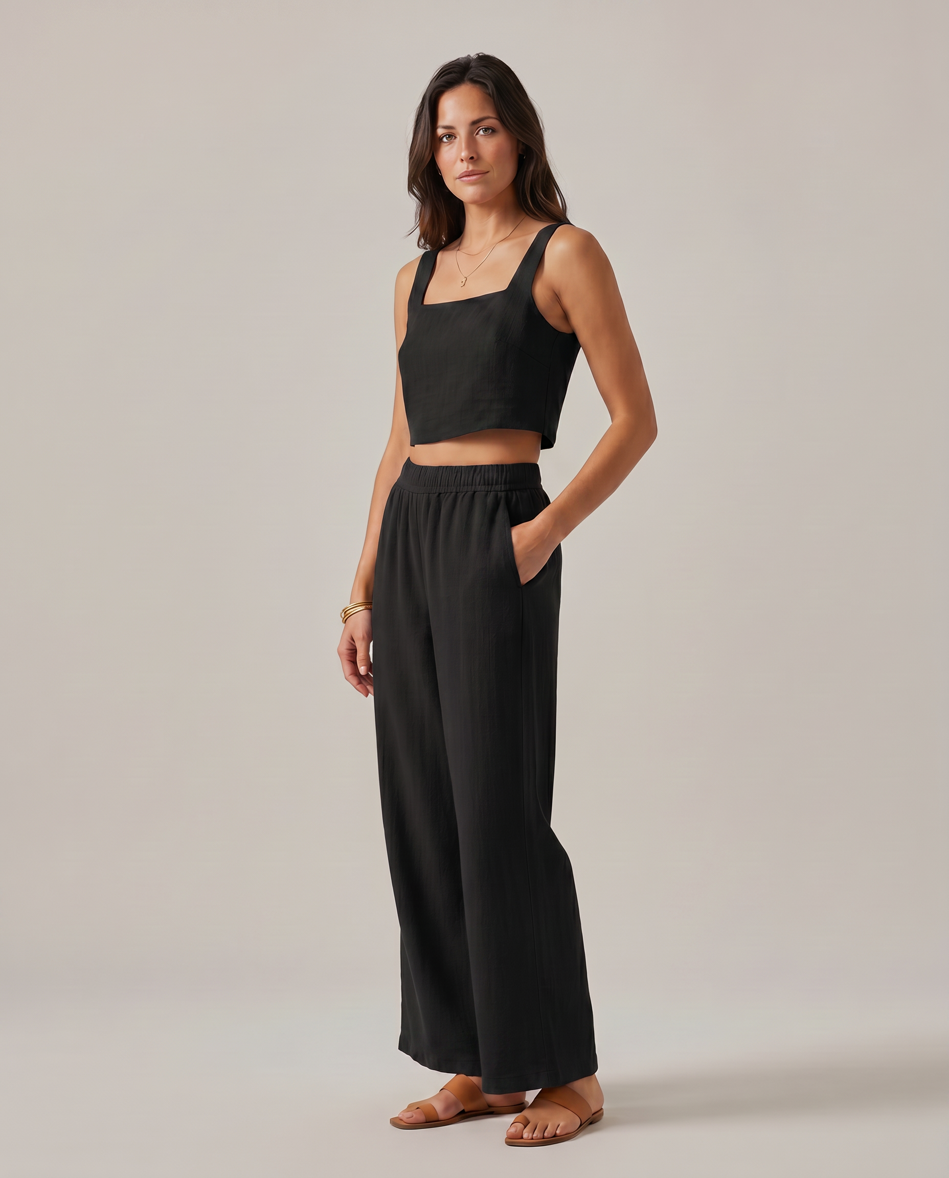 Black wide-leg two-piece set: square-neck crop top and flowy elastic-waist wide-leg trousers.