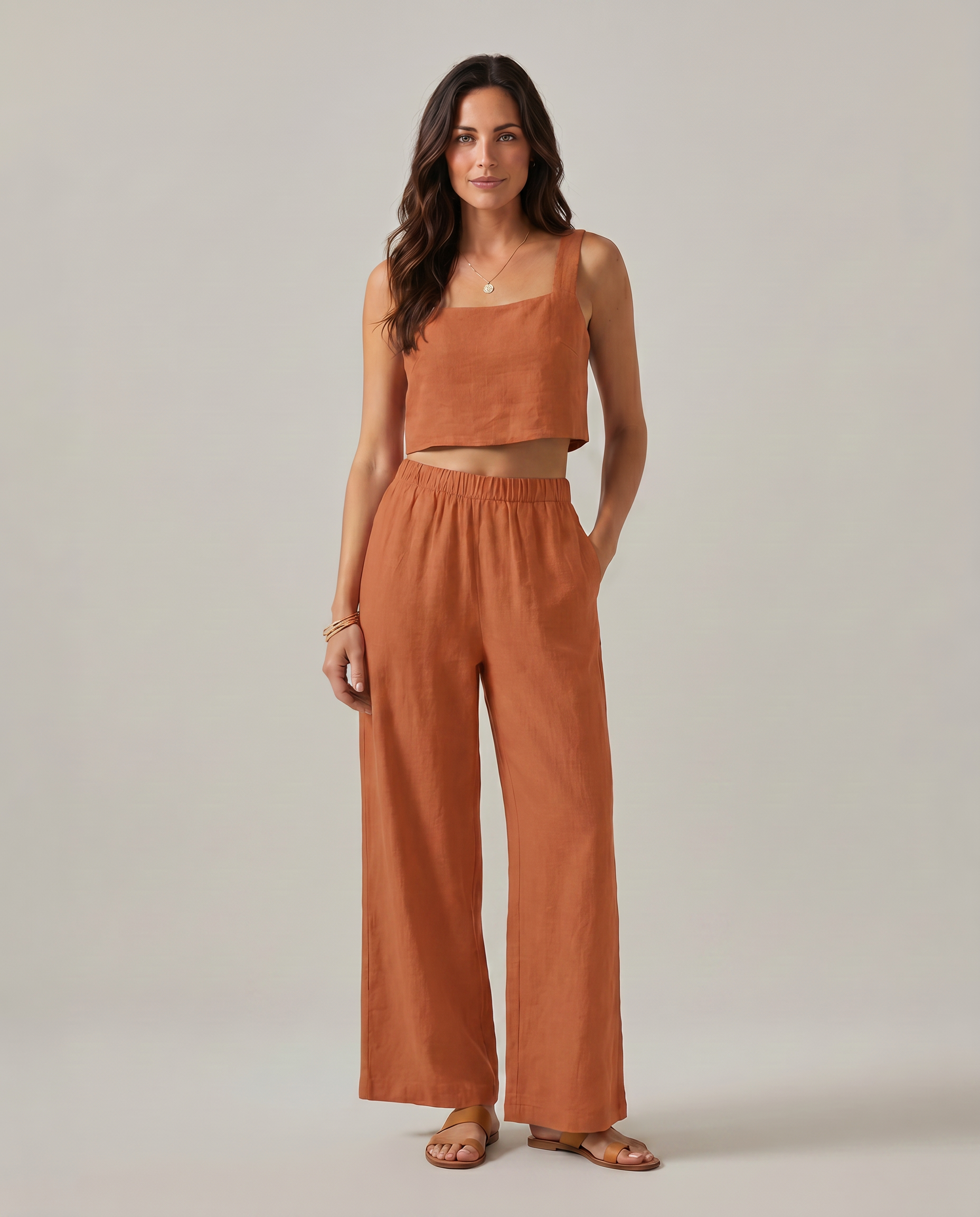 Wide-leg two-piece set in orange: square-neck cropped tank and high-rise elastic-waist pants.