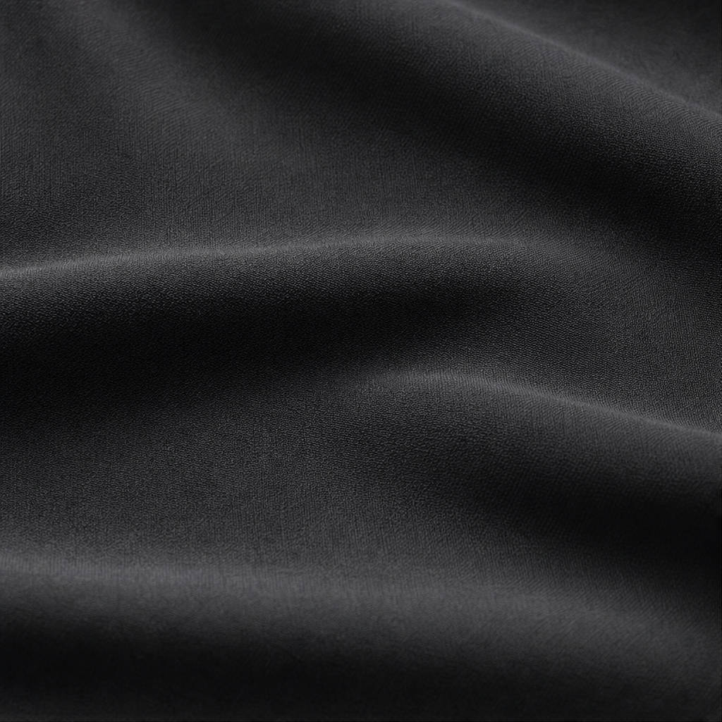 Black mesh fabric close-up with smooth, woven texture