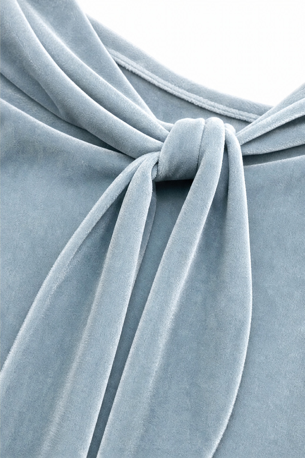 Close-up of the knotted tie neckline on a light blue velvet blouse