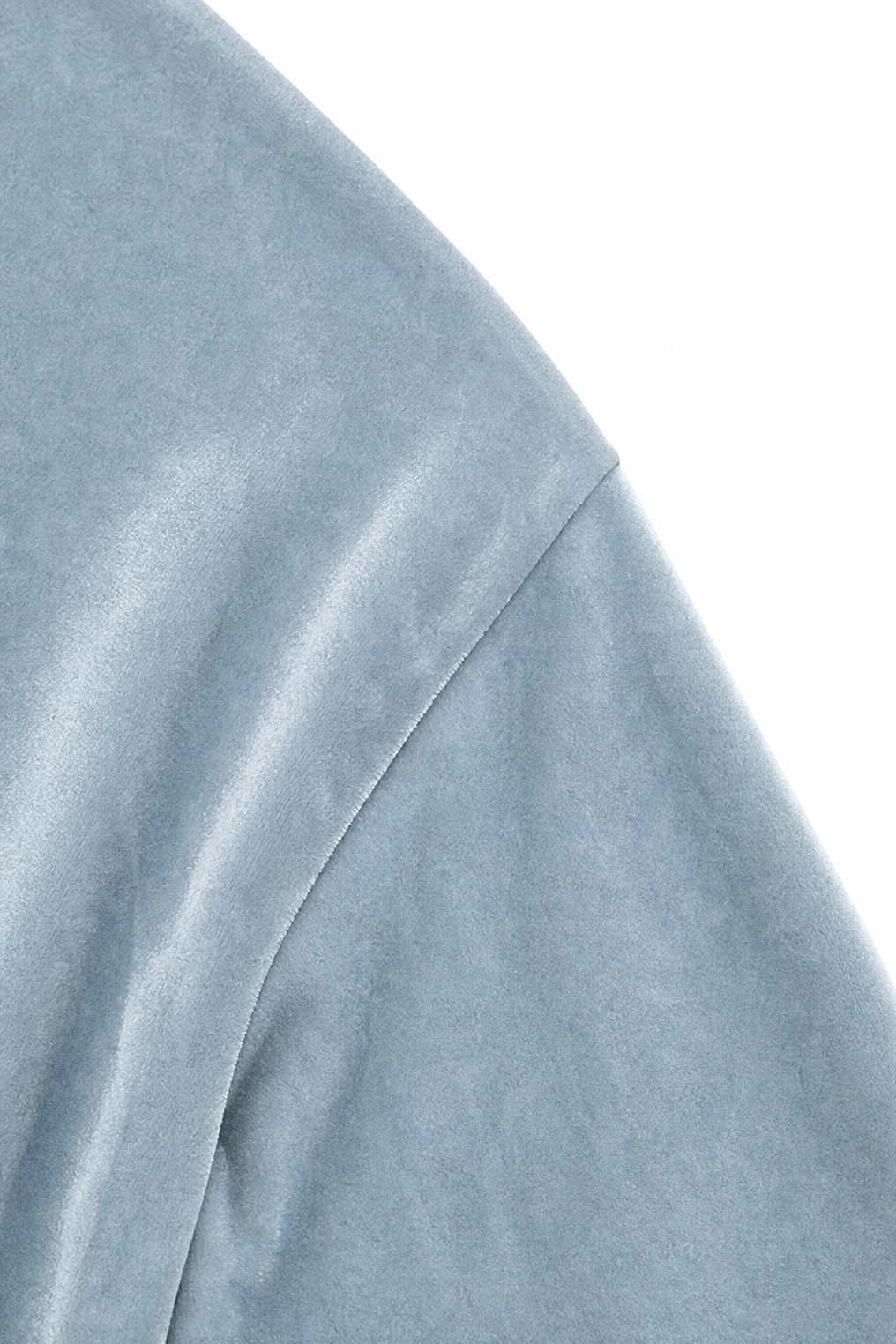 Close-up of the dropped shoulder seam on a light blue velvet blouse