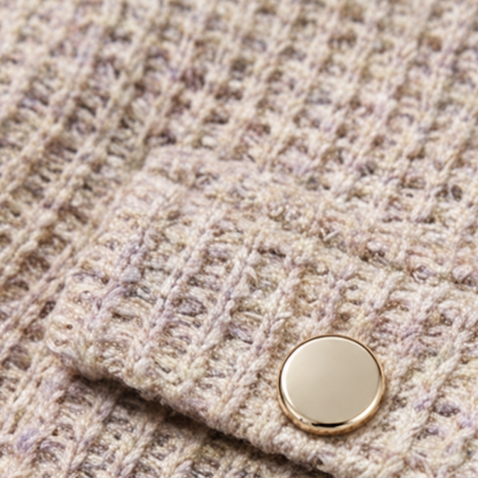 Beige waffle-knit fabric swatch with round metal-look snap detail