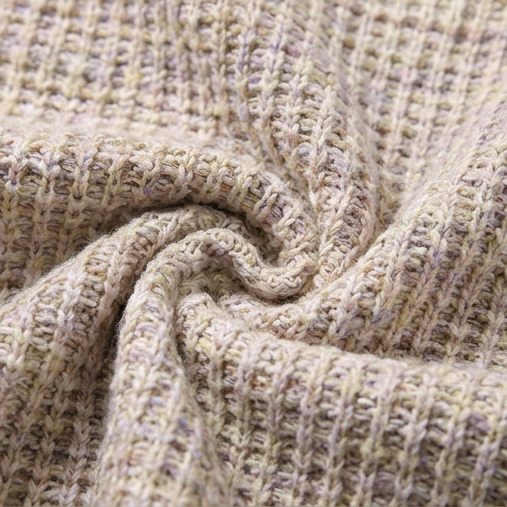 Beige waffle-knit texture close-up with raised stitch pattern