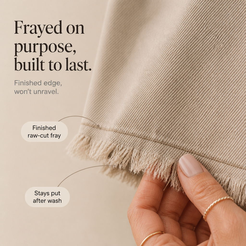 Frayed denim-look hem with raw-cut edge texture and visible stitched seam