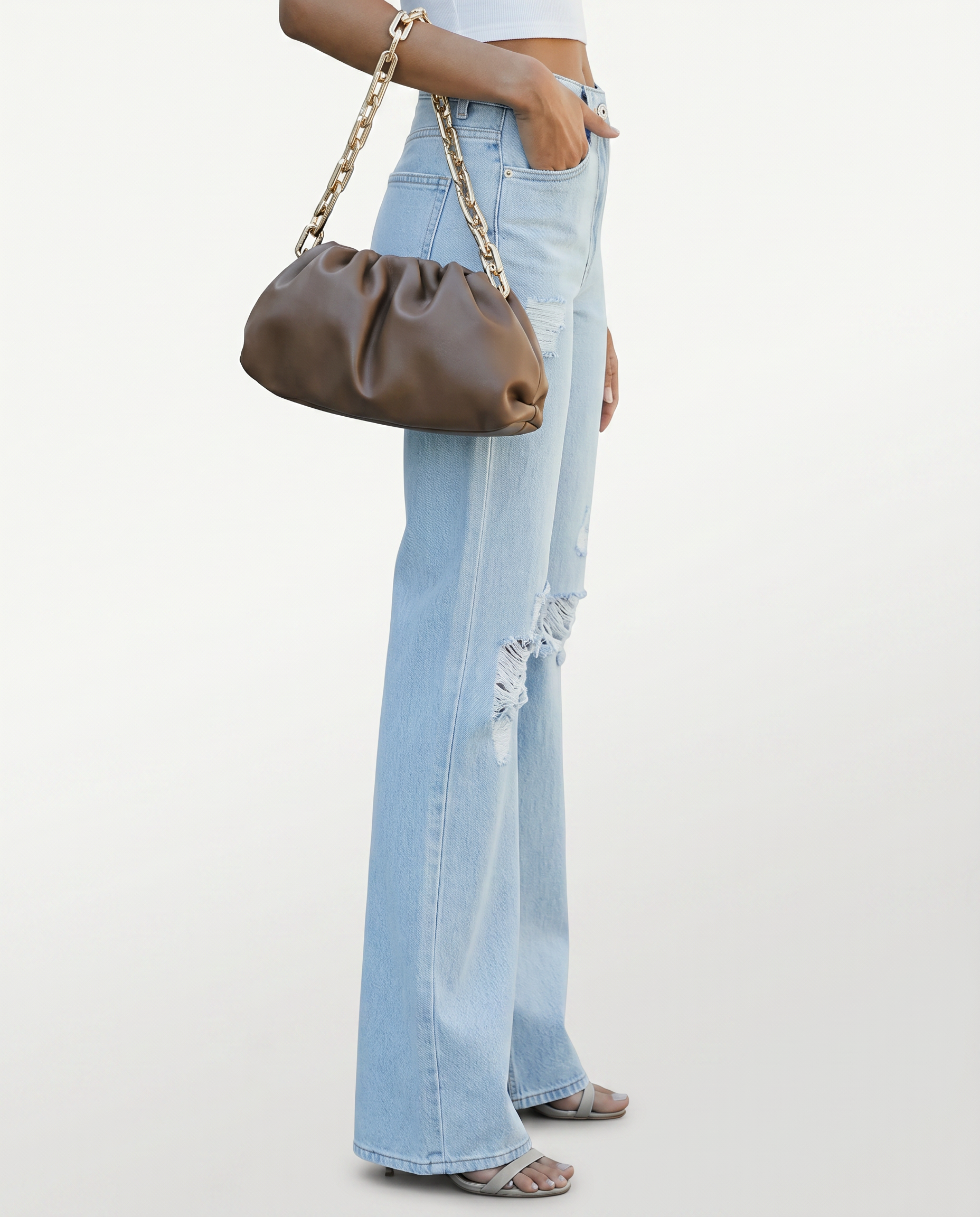 Light blue high-rise wide-leg jeans with ripped knee detailing and flared hems