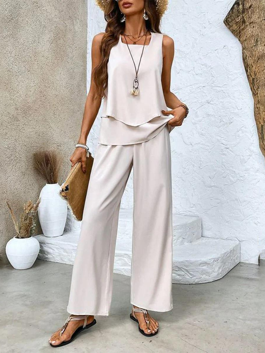 White sleeveless two-piece set with neutral wide-leg pants