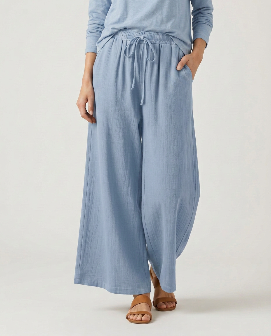 Light blue wide-leg drawstring trousers with tie waist and relaxed fit