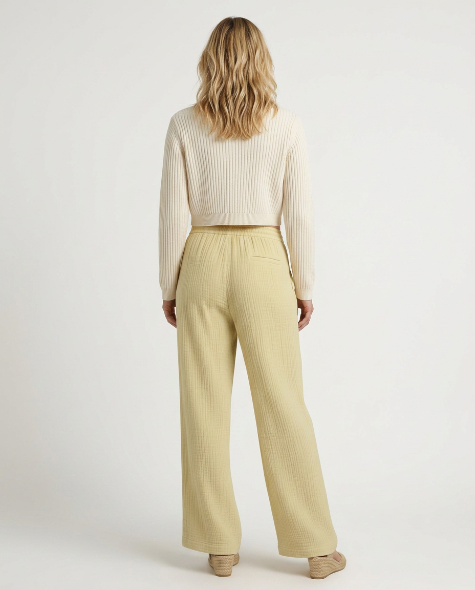 Light yellow wide-leg trousers with elastic waist and drawstring, back view