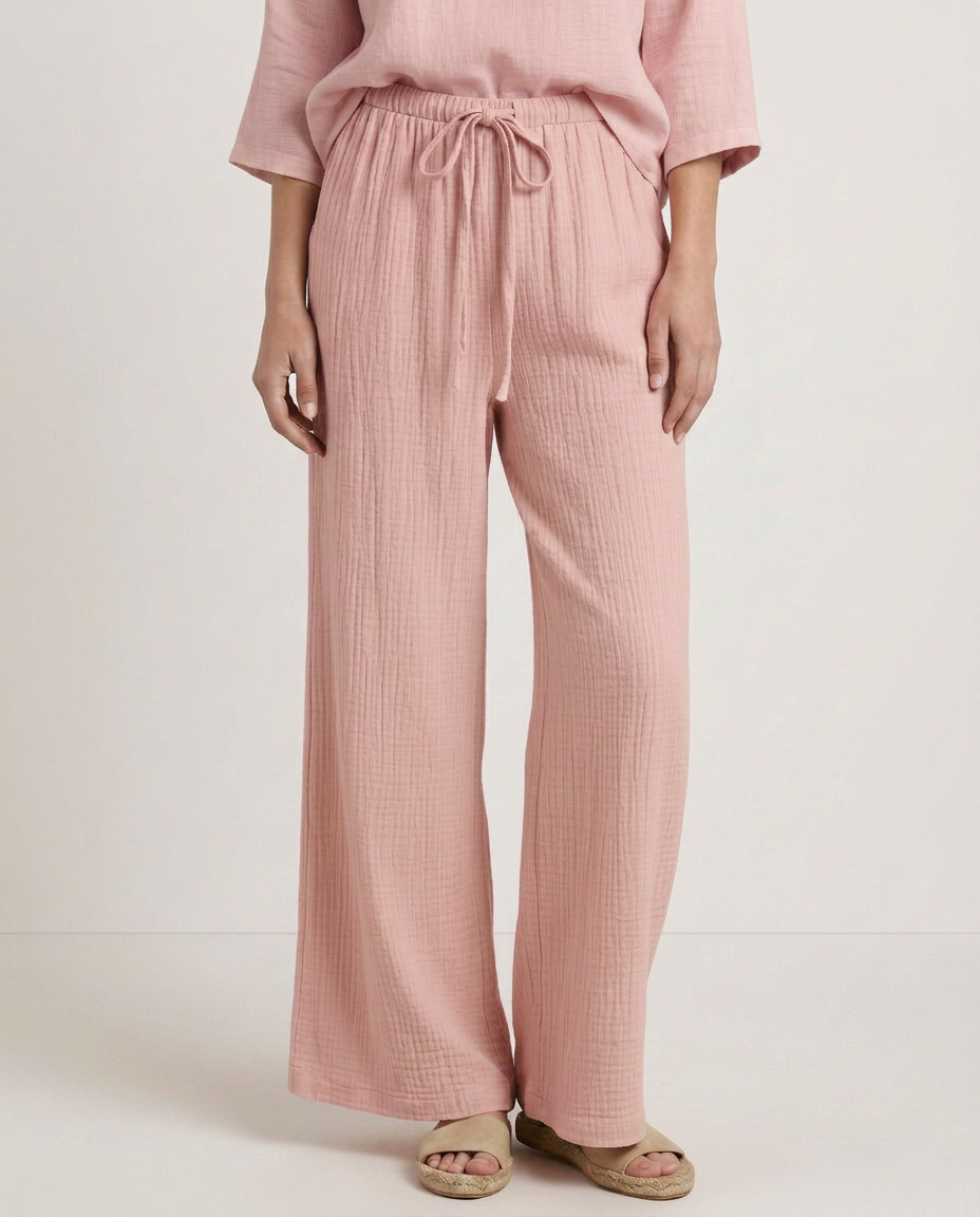 Pink wide-leg trousers with elastic waist and drawstring, textured crinkled fabric